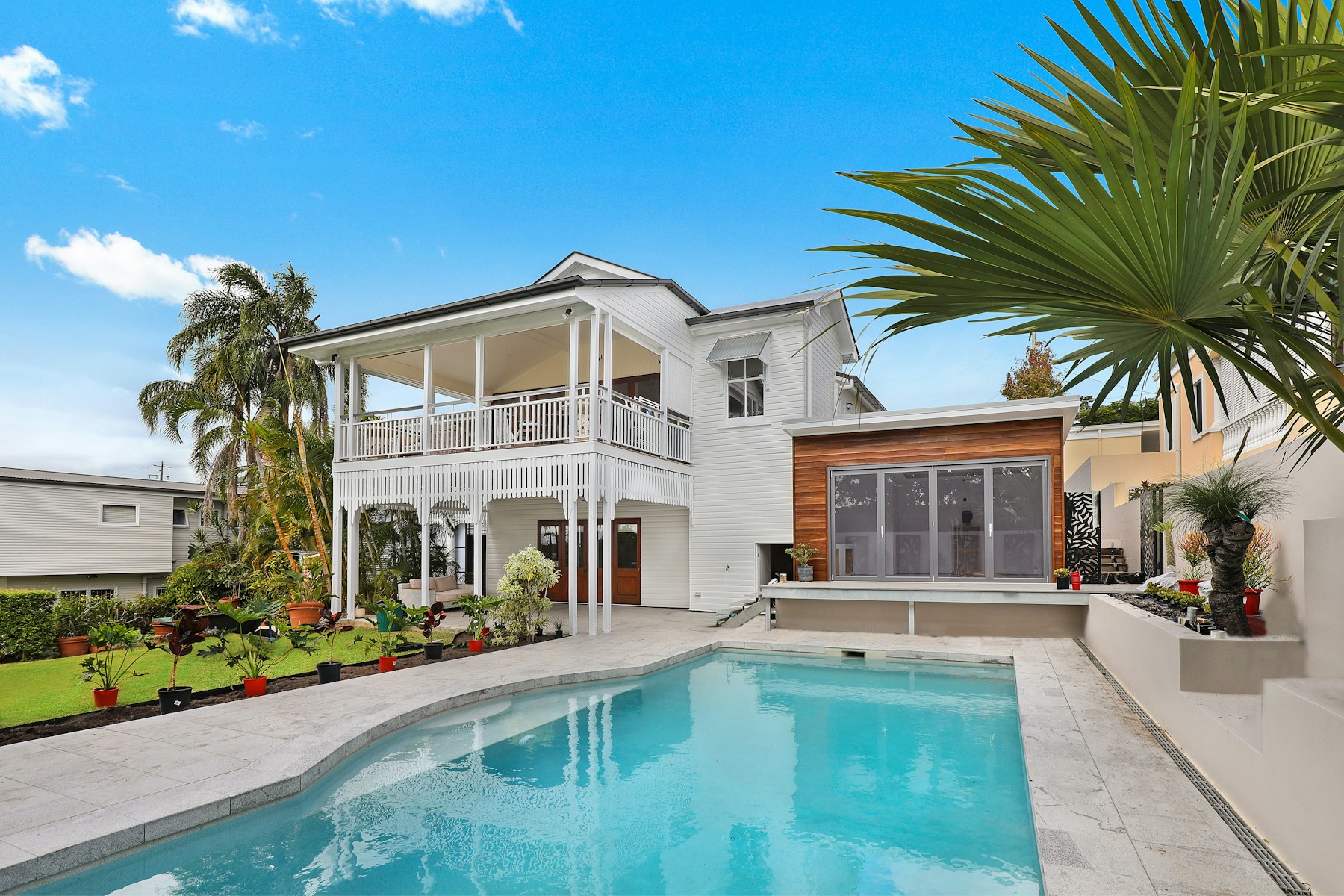 Beautiful modern home with wide finished concrete driveway and clean landscaping